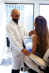 Doctor examining a patient in a medical office.