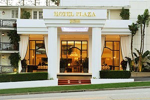 Entrance of Hotel Plaza with visible signage and exterior decor.