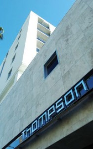 Exterior view of a modern building with the sign 'Thompson' on the facade.